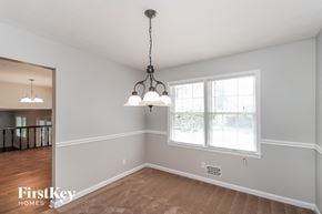 Lawrenceville house for rent - an empty dining room with two lamps and a window