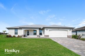 Cape Coral house for rent - A house with a white garage door is for sale by FirstKey Homes.