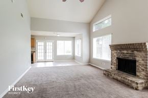 Katy house for rent - a living room with a fireplace and a carpeted floor