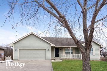 Kearney house for rent - a light green house with a tree in the front
