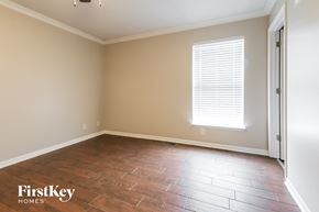 Kearney house for rent - an empty room with wood floors and a window