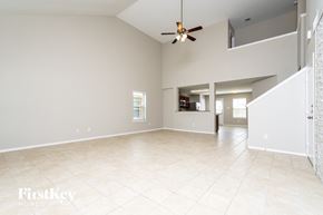 Forney house for rent - an empty living room with a ceiling fan and a tile floor