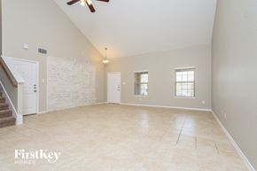 Forney house for rent - an empty living room with a staircase and a tile floor