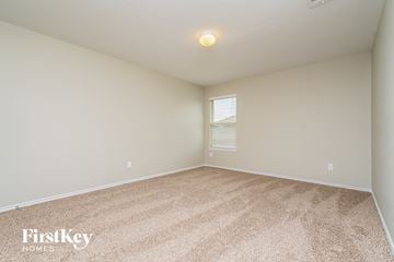 Forney house for rent - a spacious living room with beige carpet and a window