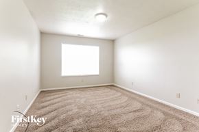 Indianapolis house for rent - a spacious room with carpet and a window