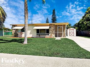 Port Charlotte house for rent - A house with a palm tree in front of it.
