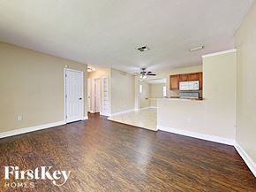 Port Charlotte house for rent - A spacious room with wood flooring and a ceiling fan.