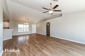 Cape Coral house for rent - the spacious living room with hardwood flooring and a ceiling fan