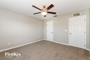 Cape Coral house for rent - a bedroom with a ceiling fan and a closet