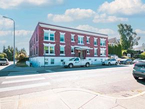 Bellingham apartment for rent - A red and white building with a white van parked in front.