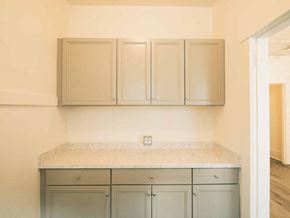 Bellingham apartment for rent - A kitchen with a marble countertop and grey cabinets.