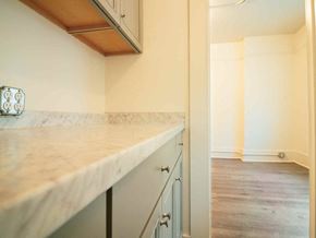 Bellingham apartment for rent - A kitchen with a marble countertop and grey cabinets.