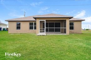 Cape Coral house for rent - A house with a brown roof and a beige exterior is for sale.