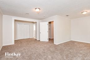 Morrow house for rent - A carpeted room with a FirstKey Homes logo.