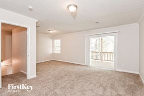 Morrow house for rent - A spacious room with a carpeted floor and a sliding glass door leading to a balcony.