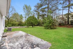 Morrow house for rent - A backyard with a concrete patio and a grassy area.