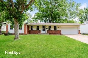 Florissant house for rent - A house with a white garage door is for sale.