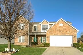 Avon house for rent - A brick house with a white garage door in front.
