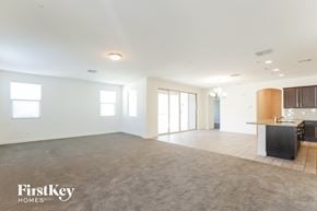 Buckeye house for rent - A spacious, empty room with a kitchenette and a dining area.