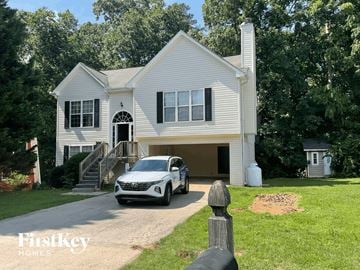 Gainesville house for rent - a car parked in a driveway in front of a house