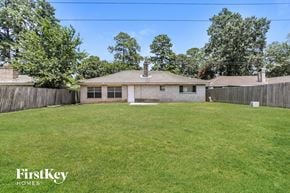 Spring house for rent - A house with a fence and a grassy yard is for sale.