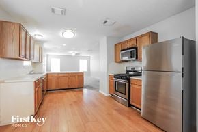 Katy house for rent - a kitchen with wood flooring and stainless steel appliances