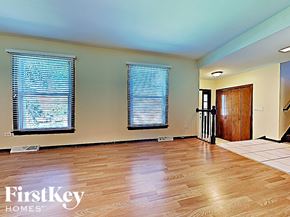Richton Park house for rent - an empty living room with a hard wood floor and windows