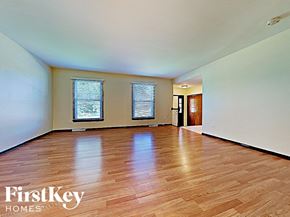 Richton Park house for rent - an empty living room with wood floors and white walls