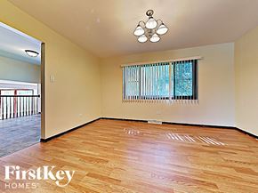 Richton Park house for rent - an empty living room with hardwood floors and a window