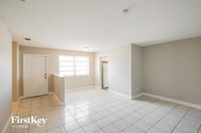 Miami Gardens house for rent - A spacious room with a door, a window, and a tiled floor.