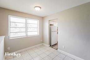 Miami Gardens house for rent - A room with a window and a door leading to another room.