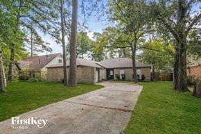 Spring house for rent - a brick house with a sidewalk and trees