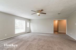 Spring house for rent - the living room of an empty house with a ceiling fan