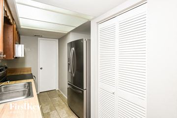 Palm Bay house for rent - a kitchen with a stainless steel refrigerator and a sink