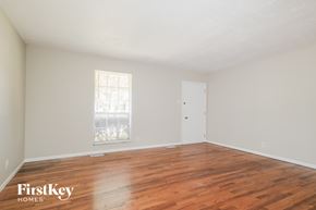 Florissant house for rent - Empty room with wooden floors and a window.