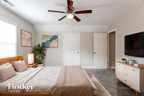 Helena house for rent - A bedroom with a bed, a ceiling fan, and a painting on the wall.