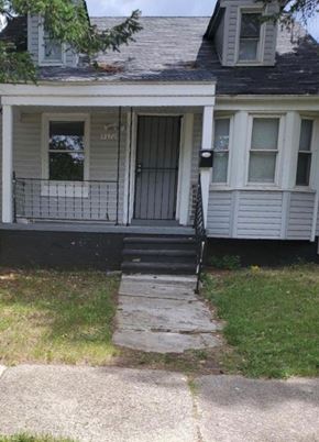 Detroit house for rent - A house with a grey door and a small porch.