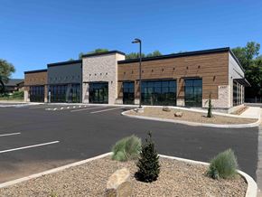 Yakima apartment for rent - A modern building with a parking lot in front.