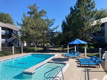Boise apartment for rent - A swimming pool surrounded by trees and chairs.