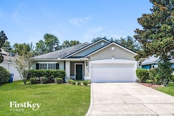 St. Augustine house for rent - a home with a driveway and a garage door