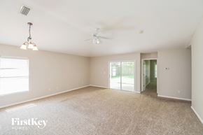 St. Augustine house for rent - a spacious living room with carpet and a ceiling fan