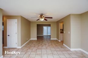 Largo house for rent - an empty living room with a ceiling fan and a tile floor