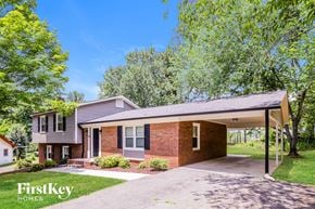 Winston-Salem house for rent - a small brick house with a covered porch and a driveway