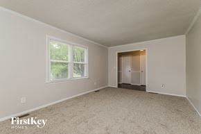 Winston-Salem house for rent - a bedroom with a carpeted floor and a large window