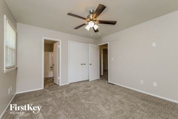 Winston-Salem house for rent - a living room with carpet and a ceiling fan