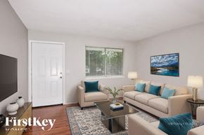 Florissant house for rent - A living room with a couch, chair, and a coffee table.