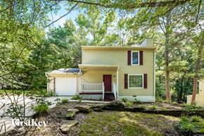 Birmingham house for rent - a small yellow house in the woods with trees
