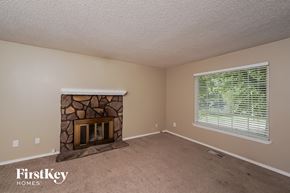 Birmingham house for rent - a living room with a fireplace and a large window