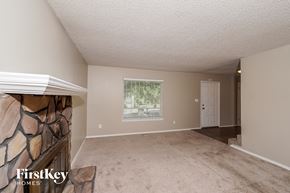 Birmingham house for rent - a living room with a fireplace and a carpeted floor