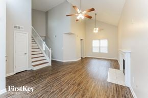 Atlanta house for rent - A spacious room with a staircase and a fireplace.